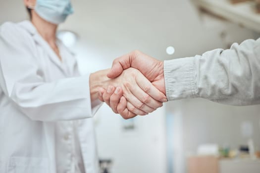 Handshake, patient and doctor with covid results, healthcare or agree on treatment plan in hospital. Hand shake, medical professional and consult for diagnosis, communication or advice for recovery.