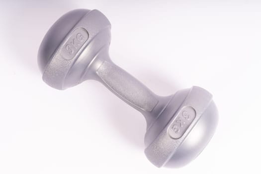 Grey dumbbell Side view closeup isolated on a white background