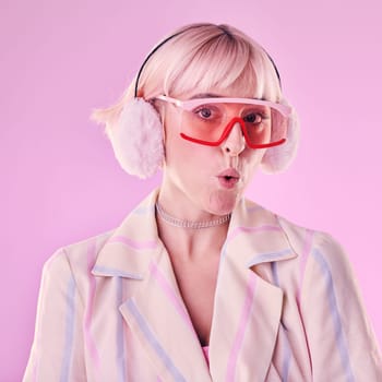 Portrait, fashion and woman with unique style, trendy and pouting lips in studio background. Face, female and girl with glasses, funky and young person with casual, edgy and fu outfit on backdrop.