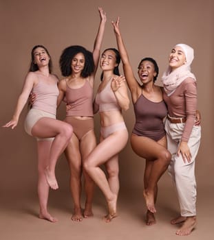 Beauty, women and celebrate diversity portrait in underwear with modest muslim woman for skincare campaign. Inclusion, happiness and body care model group with girl in hijab in brown studio