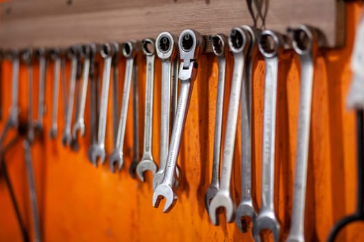 05.17.2023, Kemerovo, Moscow. Keys and work tools hang on the wall in a car repair shop or garage. Dirty, working tool of an auto mechanic