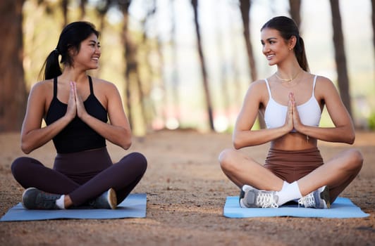 Yoga, outdoor meditation and women exercise in nature for fitness, peace and wellness. Happy people or friends smile on forest ground for zen workout, training and energy for mental health and chakra.