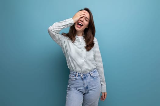 portrait of european model 25s woman with dark hair in casual clothes on studio background with copy space.