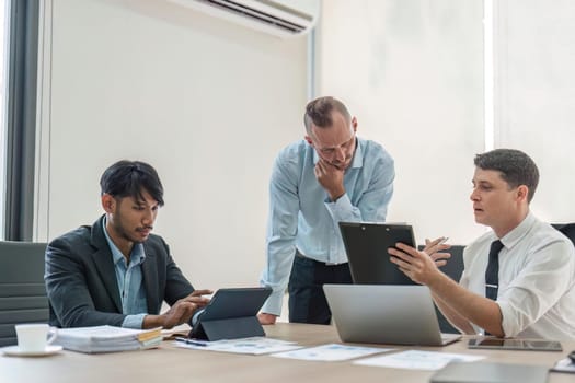 Business people, conversation and laptop data with planning and strategy in office. Training, communication and online chart with corporate paperwork and working on a teamwork project with diversity.