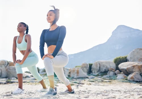 Stretching, fitness and friends with women at beach for running, yoga and workout. Relax, health and wellness with female runner and warm up in nature for training, teamwork and cardio performance.