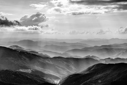 Mountain landscape with sun beams in ukrainian Carpathiaan in black and white