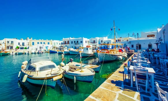 Parked boats in the harbor, near cafe at Paros, Greece