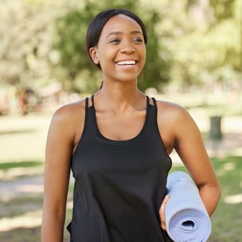 Yoga, exercise mat and mindfulness with a black woman in a park, outdoor for fitness, health or wellness. Mental health, pilates and workout with a female athlete training outside for balance.