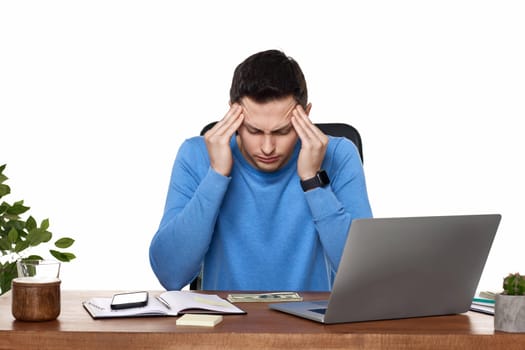 sad man have a headache, using laptop in office