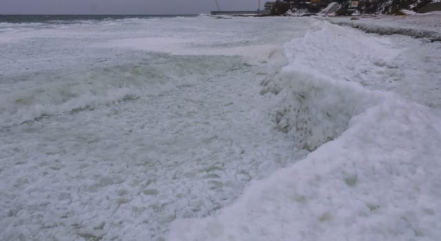 The Black Sea is frozen, the circular ice rolled by the waves is thrown ashore and frozen