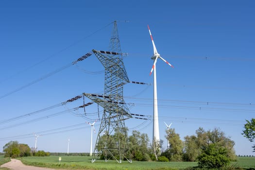 Electricity pylon and a wind turbine seen in Germany