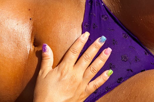 colored nails on a tanned body