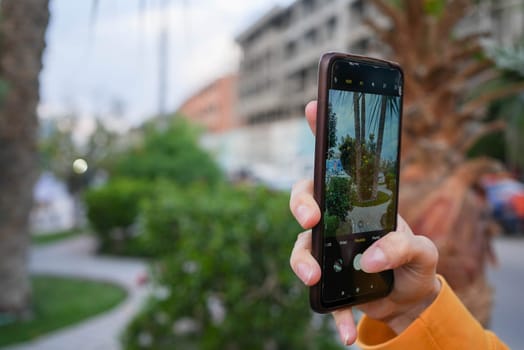 Tourist taking a vertical photo with a phone. High quality photo