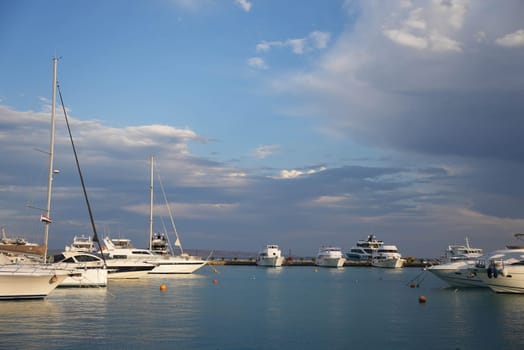 Wealthy luxury yachts docking at bay in the beautiful shining sunset . High quality photo