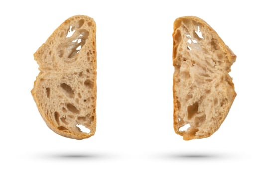 Two slices of fresh Ciabatta bread on a white isolated background. Slices hang or fall on a white background. The concept of Italian bread baking or delicious breakfast