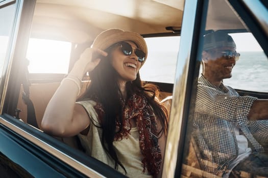 Happy couple, together and on a road trip in a car for freedom, travel and holiday. Smile, relax and a young man and woman in transportation driving for a vacation, date or an adventure in summer.