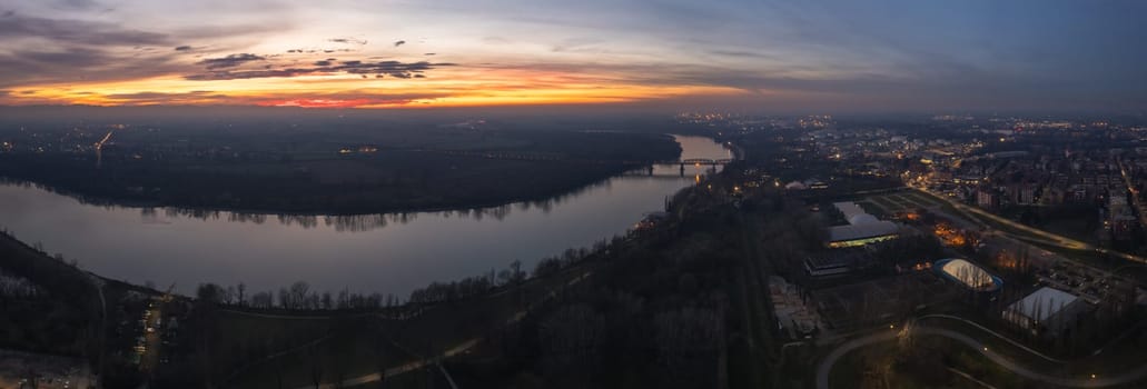 Cremona, Italy - January 2023 Sunset in plain near the city, Po bridge connecting Emilia Romagna and Lombardy