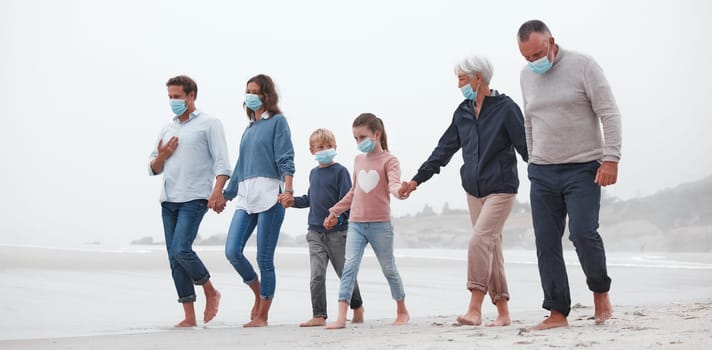 Big family, covid and holding hands walking on beach for quality bonding time together during pandemic in nature. Hand of parents, grandparents and kids in travel, freedom and family walk with masks.