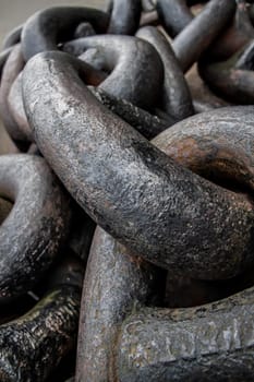 Detail on huge old ship chain, rust showing under paint in some parts.