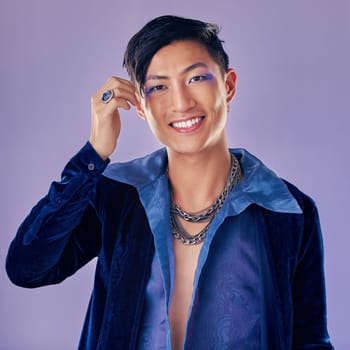 Man, makeup and luxury fashion aesthetic for lgbtq cosmetic skincare wellness. Retro beauty Asian model, facial portrait and gen z pop art clothing design or vintage style in purple background studio.