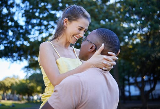 Love, park and laugh with an interracial couple bonding outdoor together on a romantic date in nature. Summer, romance and diversity with a man and woman dating outside in a green garden.