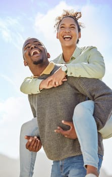 Piggyback, laugh and and love with a black couple having fun together outdoor during a summer day. Dating, romance and carefree with a man carrying a woman on his back outside on holiday or vacation.