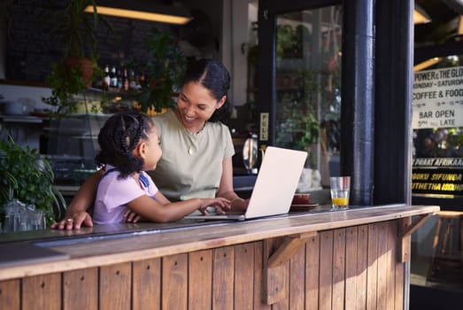 Black family, coffee shop or laptop with a mother and daughter together in the window of a restaurant. Kids, computer or education with a woman and female child sitting or bonding in a internet cafe.