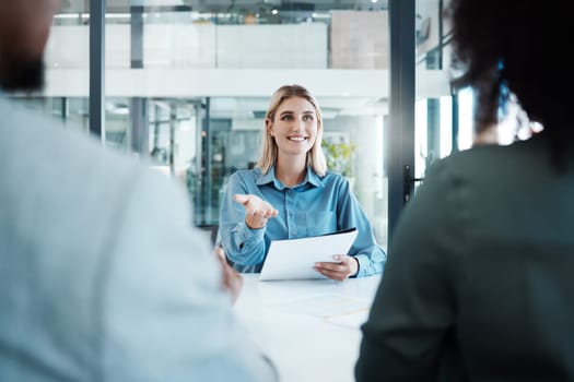 Meeting, planning and strategy with a business woman and team talking about company vision in the boardroom. Documents, teamwork and communication with a female employee in discussion with colleagues.