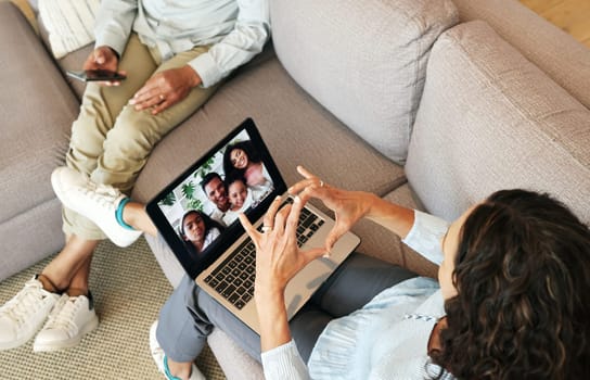 People on video call, family and heart hand with love, laptop screen and communication, grandparents and bonding. Emoji, connection and hands, relax at home with virtual chat in lounge top view.