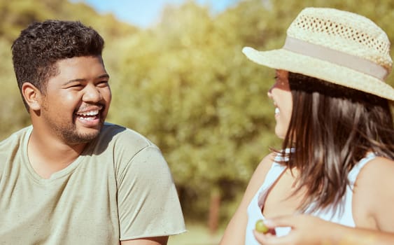 Happy, love and couple in nature in a conversation while on an outdoor garden picnic date in summer. Happiness, communication and young man and woman with a smile talking in a park to relax together