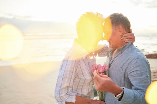 Flare, mockup and romance on the beach with an old couple outdoor in nature to celebrate valentines day. Summer, love or flowers with a senior man and woman celebrating on the coast together.