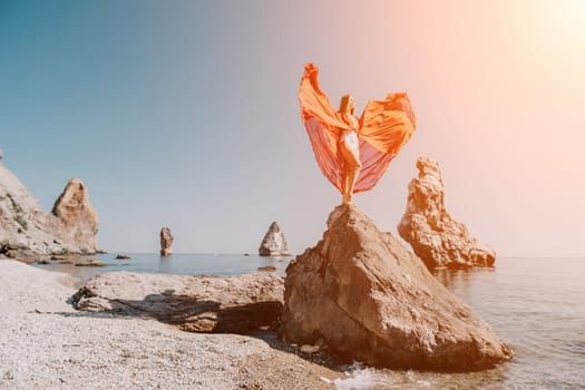 Woman travel sea. Happy tourist taking picture outdoors for memories. Woman traveler looks at the edge of the cliff on the sea bay of mountains, sharing travel adventure journey.