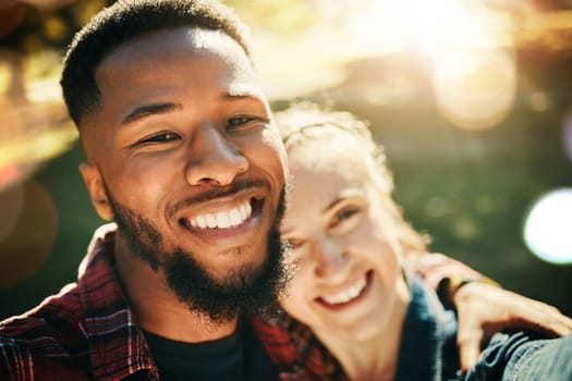 Couple, love selfie and portrait smile at park outdoors, enjoying fun time and bonding together. Diversity, romance and face of black man and woman taking pictures for happy memory or social media