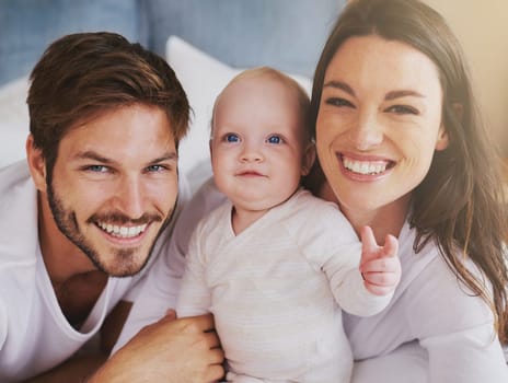 Portrait of happy family, baby and parents with love, care and quality time together at home. Mom, dad and cute newborn kid relaxing with smile, happiness and support of healthy childhood development.
