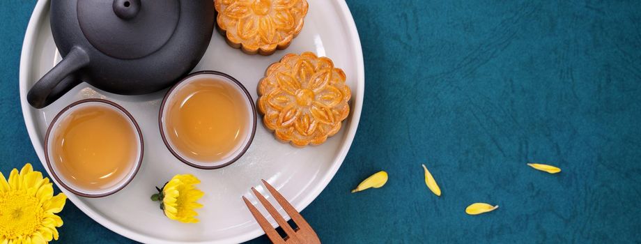 Minimal simplicity layout moon cakes on blue background for Mid-Autumn Festival, creative food design concept, top view, flat lay, copy space.