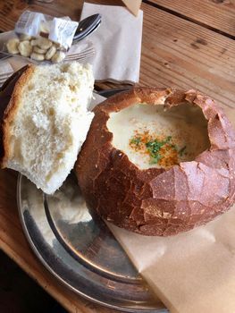 Vertical closeup of a bread bowl of New England Clam Chowder