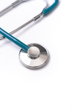 Green stethoscope, object of doctor equipment for heartbeat trace, isolated on white background. Medical design concept, close up and studio shot.