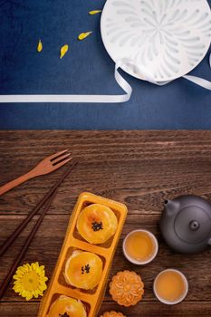 Creative Moon cake Mooncake design inspiration, enjoy the moon in Mid-Autumn festival with pastry and tea on wooden table concept, top view, flat lay