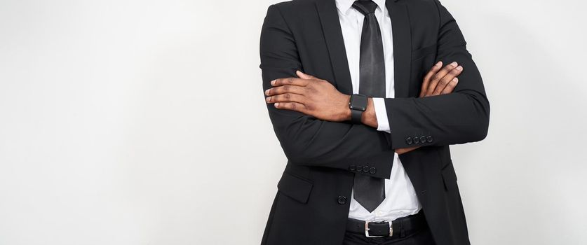 Portrait of successful african office worker with arms crossed over grey background