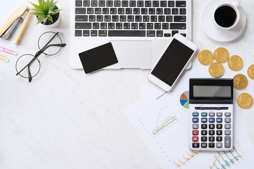 Concept of online payment with credit card with smart phone, laptop computer on office desk on clean bright marble table background, top view, flat lay