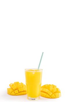 Fresh tropical mango juice with beautiful diced pulp and striped paper straw isolated on white background table, close up, cut out, clipping path.