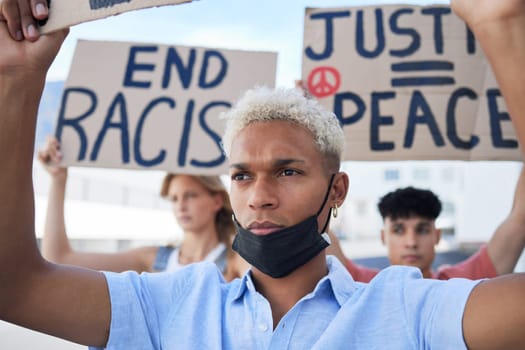 Man, crowd and protest for peace, racism and justice in street with poster in hands. People, sign and writing on cardboard for solidarity, freedom and diversity of race and human rights.