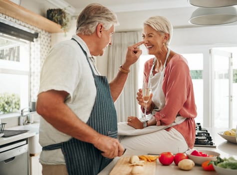 Champagne, cooking and senior couple in kitchen celebrate retirement with healthy food, vegetables or salad for vegan lifestyle. Celebrate, luxury and elderly woman celebrate with alcohol wine glass.