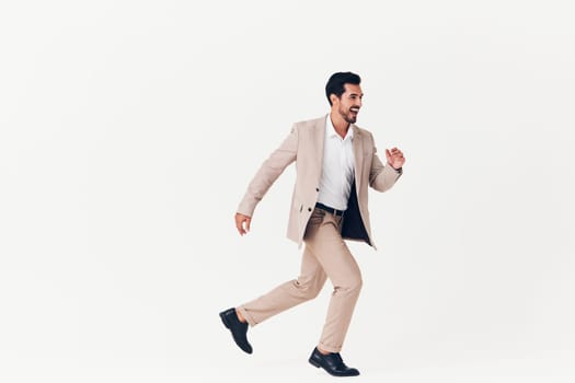 man copyspace job attractive happy studio suit work businessman winner smiling portrait flying victory business shirt jacket model beige office isolated running