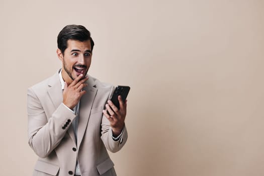 man communication happy suit gray lifestyle technology call beard phone smartphone cellphone young hold beige smile portrait white business guy confident