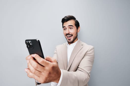 space man smile gray trading hold business isolated happy portrait call cellphone phone message studio cyberspace beige suit young smartphone businessman copy