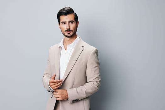 man sexy suit handsome arm smiling beige happy corporate business young posing occupation portrait guy businessman copyspace beard folded tie background