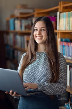 Vertical shot of young female student making a research for classes