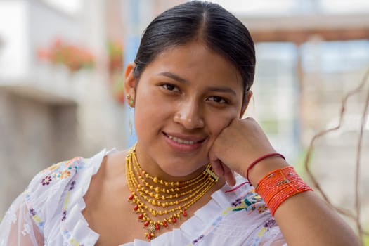 closeup of beautiful indigenous woman with traditional dress of her culture looking and smiling at camera. High quality photo