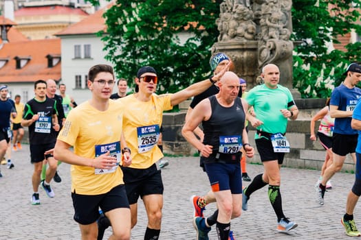 Prague, Czechia - 7th May 2023 - Group athletes runners run marathon in a sunlight